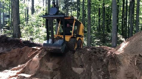 digging a basement with a skid steer|digging holes with skid steer.